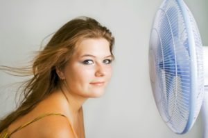 The fan blows to face of woman